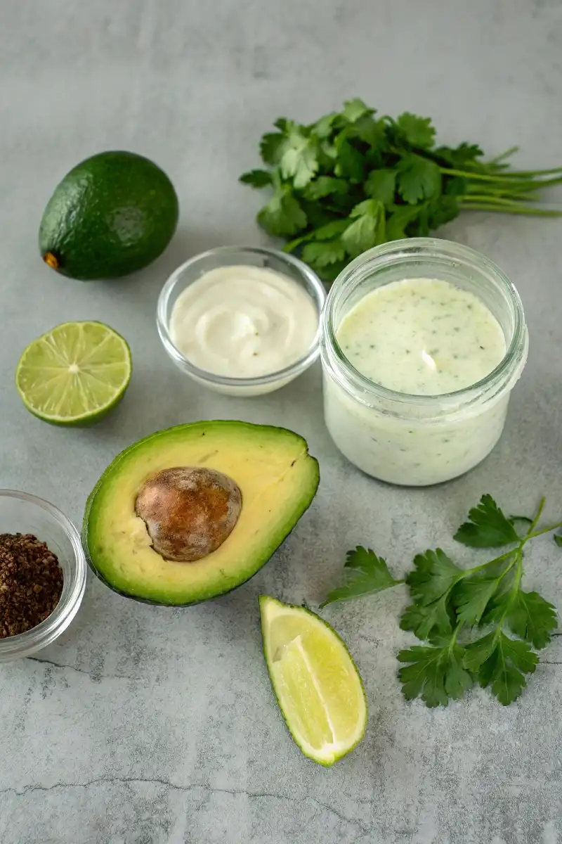 • 1 large ripe avocado (approximately 200 g), pitted and peeled, ensuring a creamy texture that forms the heart of this dressing. • ½ cup (120 ml) full-fat plain Greek yogurt, which brings a tangy creaminess reminiscent of traditional ranch. • ¼ cup (60 ml) buttermilk, for that slight tang and extra creaminess that binds the flavors together. • 2 tablespoons (30 ml) extra-virgin olive oil, to add a silky finish and subtle fruity notes. • Juice of 2 fresh limes (approximately ¼ cup or 60 ml), delivering a bright acidity that cuts through the creaminess. • 2 garlic cloves, finely minced, to infuse a gentle warmth and depth into the dressing. • ½ teaspoon onion powder, for a mellow yet essential layer of savory flavor. • ½ teaspoon dried dill weed, a perfect herb that echoes traditional ranch seasoning. • ½ teaspoon dried chives, providing a mild, onion-like taste without overpowering the other components. • 1 tablespoon fresh parsley, roughly chopped, to add a burst of color and an extra fresh herbaceous note. • Salt and freshly ground black pepper, to taste (approximately ½ teaspoon salt and ¼ teaspoon pepper recommended as a starting point). • 2 to 3 tablespoons water, as needed, to adjust the dressing to your desired consistency.